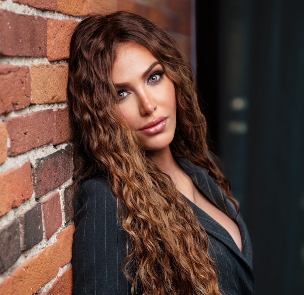 a person standing in front of a brick building