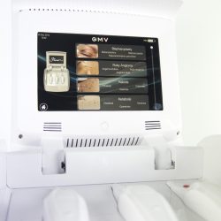 White medical device touchscreen showing GMV menu for blepharoplasty, ruby angioma, keloids and keratosis treatments.